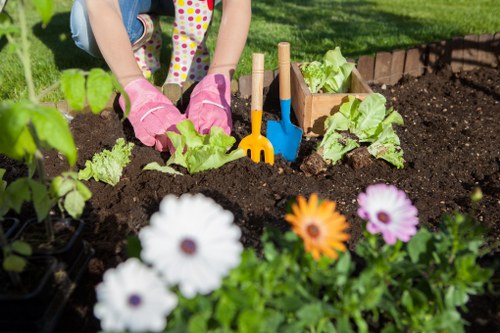 Composted garden soil being spread on a planting bed